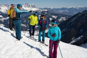 Skifahrende stehen am Hang im Skiurlaub im Brixental